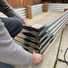 a man is working on some metal slats