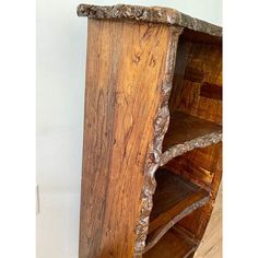 an old wooden bookcase with many shelves