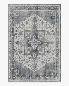 a gray and white rug with an intricate design