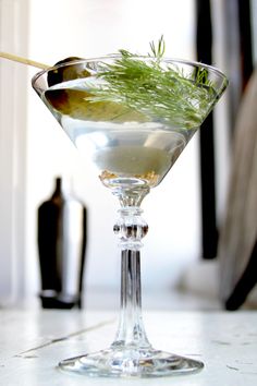 a martini glass filled with liquid and garnish