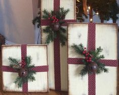 three wooden boxes with christmas decorations on them