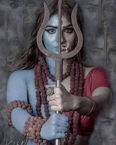 a woman with blue makeup holding a large wrench