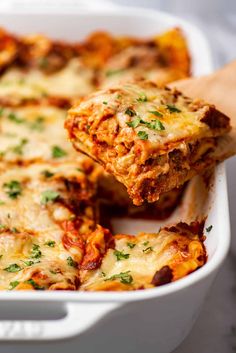 a casserole dish filled with meat and cheese, topped with parmesan