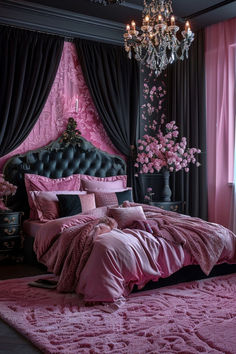 a bedroom with pink bedding and chandelier hanging from the ceiling next to a window