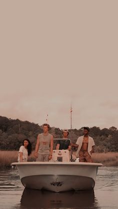 four people are standing on the back of a boat in the water with trees in the background