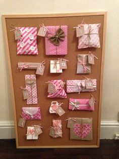 a bulletin board with pink and white wrapped presents