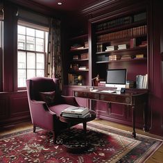 a chair and desk in a room with bookshelves on either side of the window