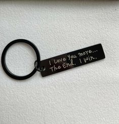 a keychain that says i love you more the end i win on it