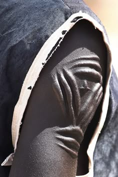 an image of a person's head with the hood pulled back and fabric covering it