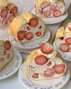 several strawberry cream filled pastries on plates