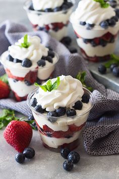 small desserts with whipped cream, berries and mint leaves