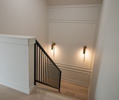 an empty room with white walls and black railing