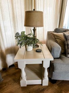 a living room with a couch, table and lamp