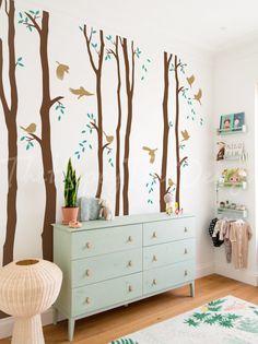 this is an image of a child's room with trees and birds on the wall