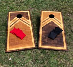 two pieces of wood with black and red cloths on them sitting in the grass