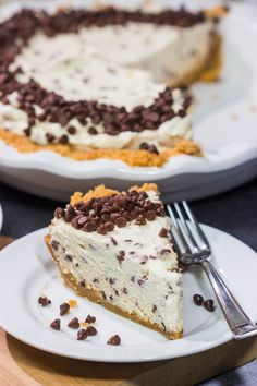 a slice of chocolate chip cheesecake on a white plate with a fork next to it