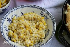 a bowl filled with rice and corn next to a skillet full of other food