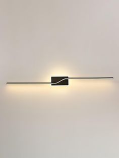 a wall light that is mounted on the side of a wall in a white room