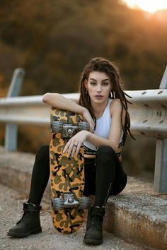 a young woman sitting on the steps with her skateboard in front of her and looking at the camera