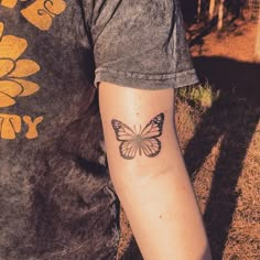 a person with a butterfly tattoo on their arm