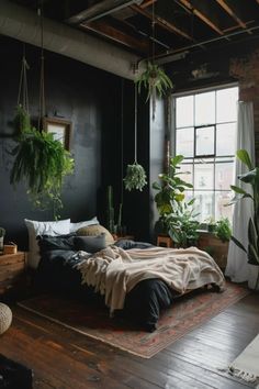 a bedroom with black walls and plants hanging from the ceiling, along with a bed