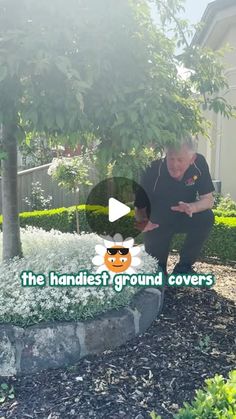 an older man is standing in front of a tree and has his hands on the ground