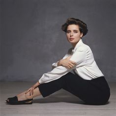 a woman sitting on the floor with her legs crossed