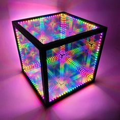 an illuminated cube in the middle of a room