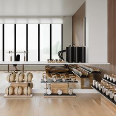 a room filled with lots of different types of items on wooden shelves next to large windows