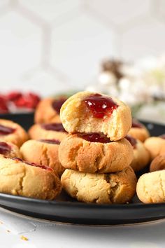 a black plate topped with cookies covered in jelly