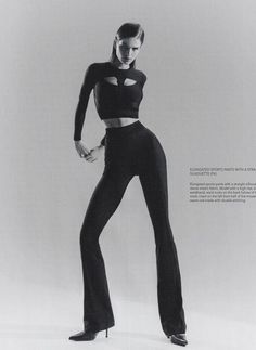 a black and white photo of a woman in high - waisted pants with cutouts