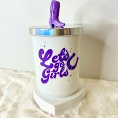 a white cup with purple letters and a purple boot on top that says let's go girls