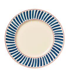 a blue and white plate on a white background with red trimming around the edge