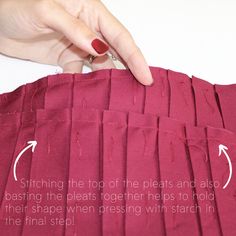 someone is stitching together pieces of fabric to make an origami style pillow