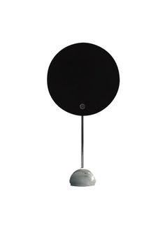 Table and wall lamp with a circular reflector in aluminum, which shields the lighting distribution, giving the effect of a solar eclipse. The circular screen is painted in white and black, the stem and the metal small parts and hemispherical support are chromed. Table version with base in white marble. Solar Eclipse, White Marble, Wall Lamp, White And Black, Solar, Marble, Table Lamp, Screen, Lighting