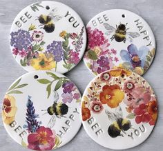 three ceramic tags with flowers and bees on them that say bee you, bee happy