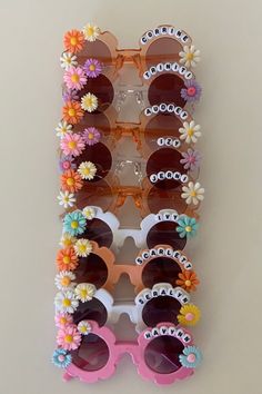 several pairs of sun glasses with flowers on the frames and sunglasses attached to each pair