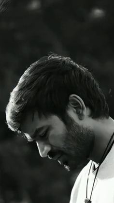 black and white photograph of a man with a beard looking down at his cell phone