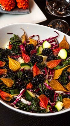 a white bowl filled with fruit and veggies