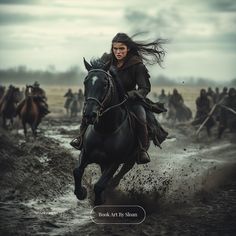 a woman riding on the back of a black horse across a muddy field next to other horses