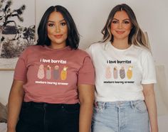 two women standing next to each other wearing t - shirts that say i love burritos