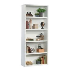 a white book shelf with books and other items on it's shelves, against a white background