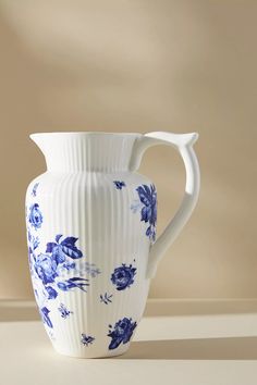 a blue and white vase sitting on top of a table