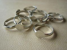 several silver rings sitting on top of a table