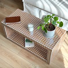 a table with a potted plant on it and some books sitting on top of it