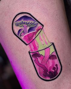 a woman's leg with a tattoo on it that has an image of mushrooms in a jar