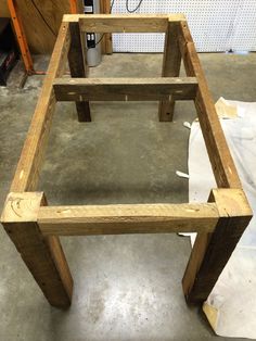 a wooden frame sitting on top of a cement floor