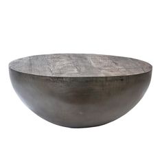 a large metal bowl sitting on top of a white surface with no one around it