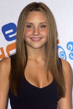 a young woman with long hair smiling at the camera