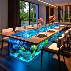 a dining room table with an aquarium in the center